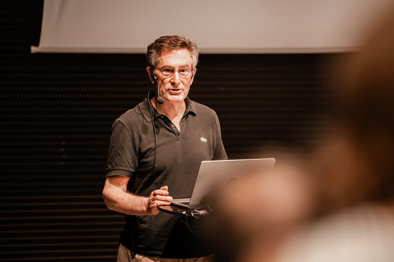 A speaker presenting at the symposium